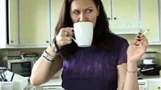 Sexy MILF makes herself some coffee while smoking porn video